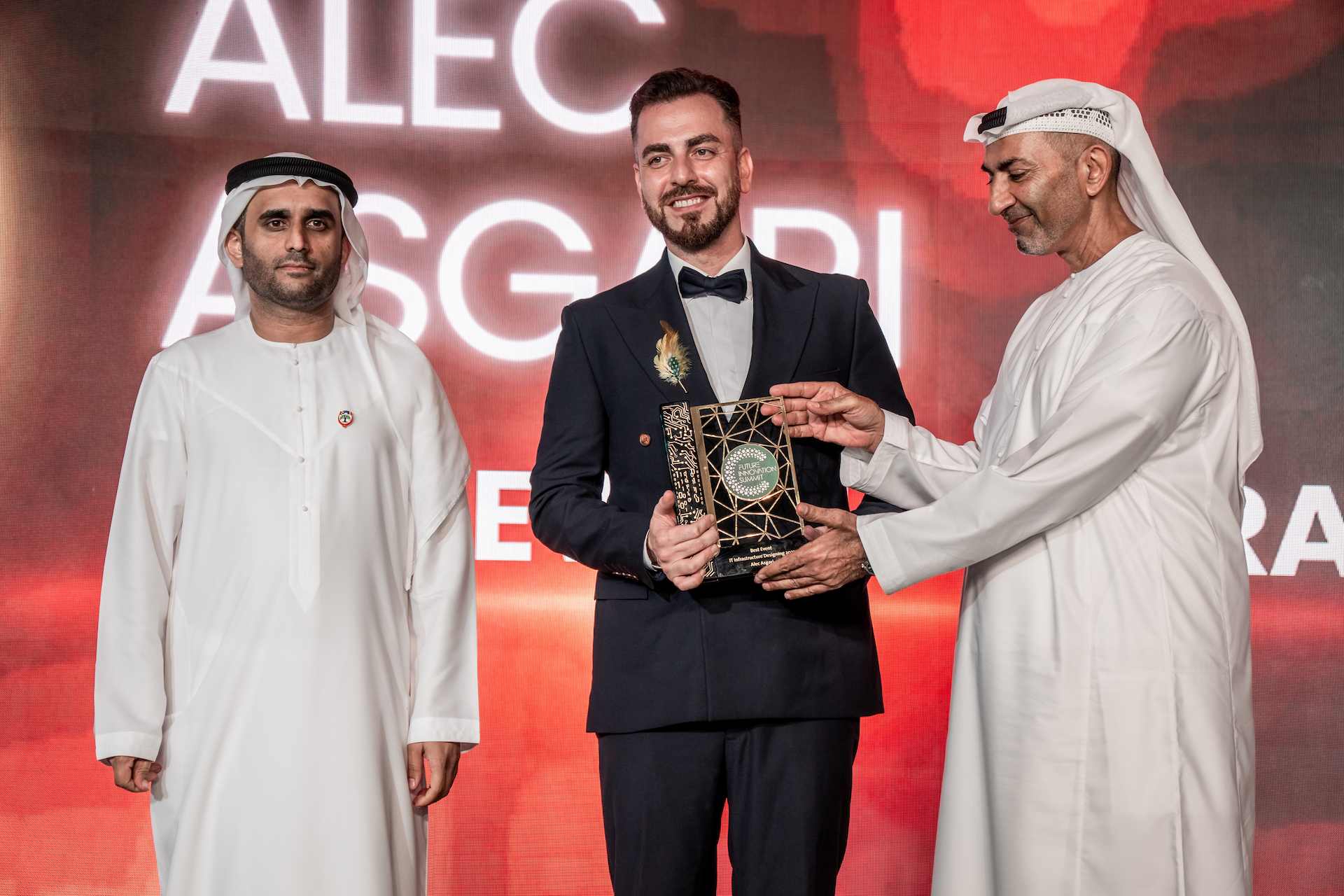 Alec Asgari receiving an award on stage at the Future Innovation Summit in Dubai